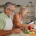 Elderly couple cooking a healthy dinner