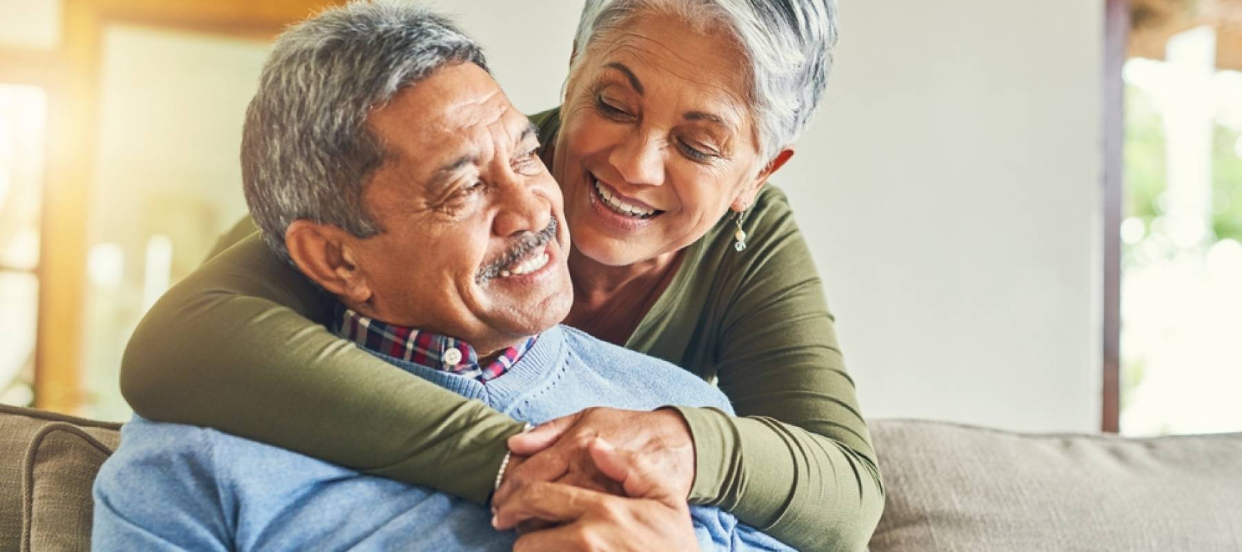 Happy elderly couple hugging