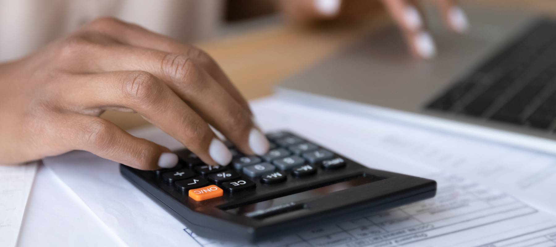 Woman uses calculator to help with financial plan