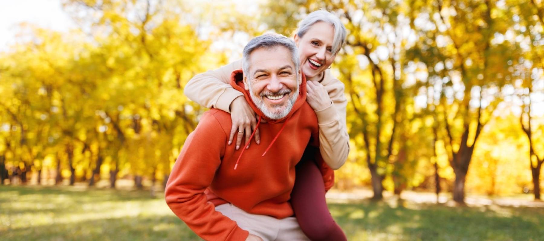 Portrait of lovely happy elderly couple on morning run outside in city park