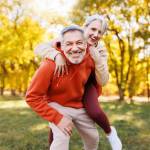 Portrait of lovely happy elderly couple on morning run outside in city park
