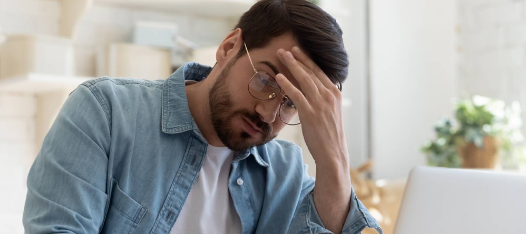 Upset frustrated young man reading bad news