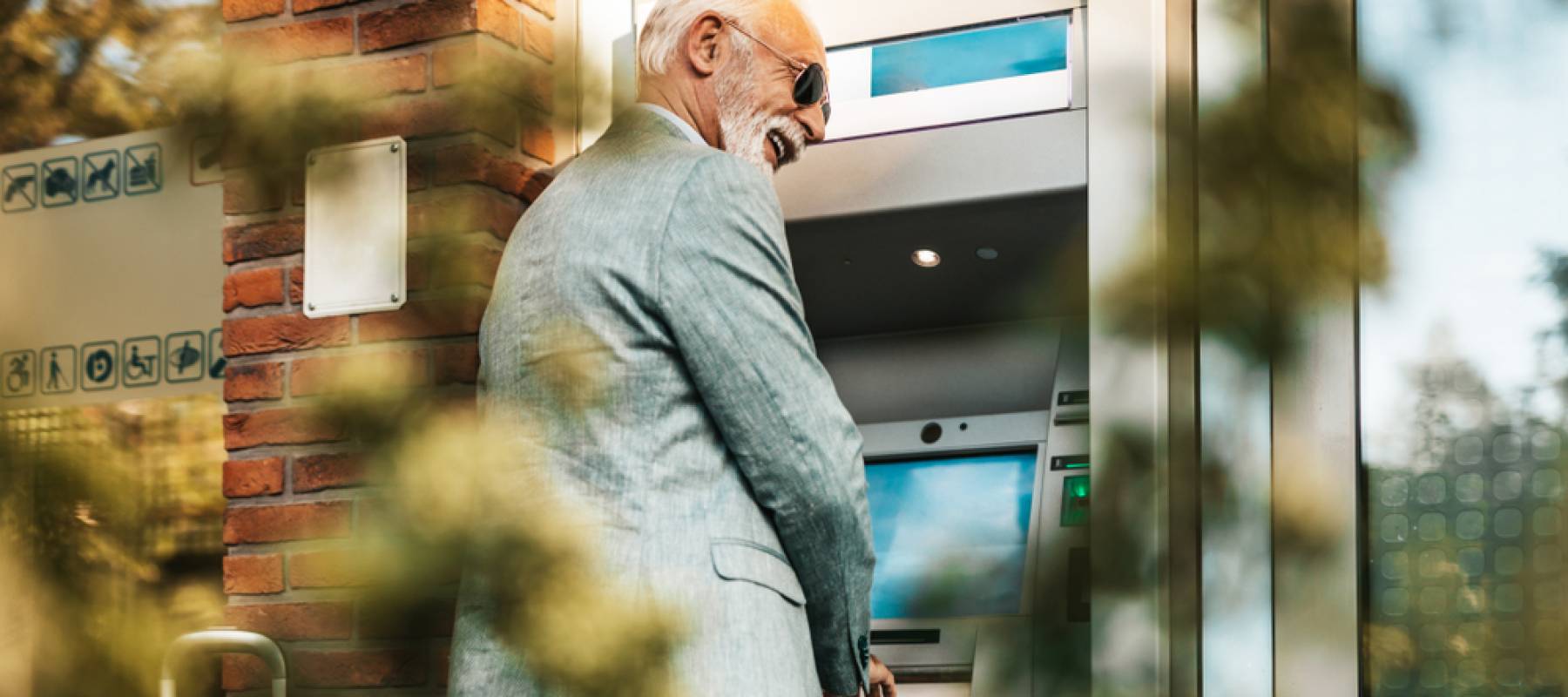 Older man using ATM