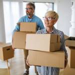 Happy retired senior couple moving into a new home, apartment.