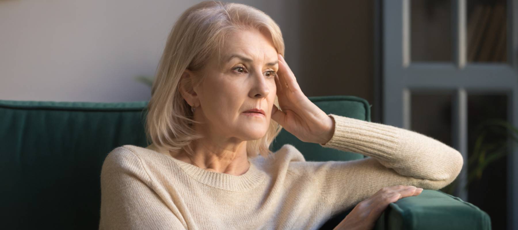 Pensive thoughtful middle aged lady looking away