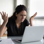 Angry looking woman on computer