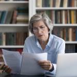 Serious thoughtful middle-aged woman in glasses looks worried