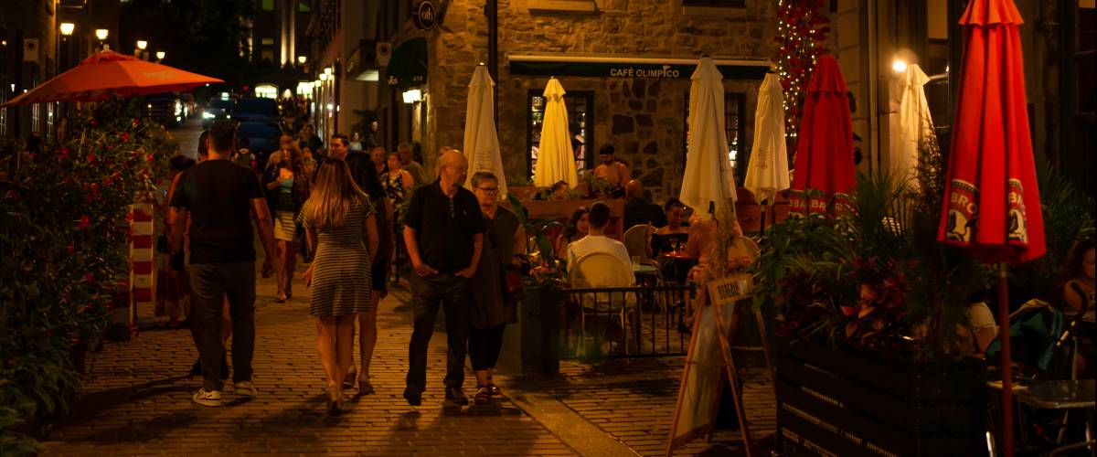 People walking in the Old Port of Montreal and Bonsecours Market at dusk