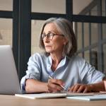 Woman at keyboard studying.