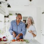 Elderly couple cooking in a kitchen