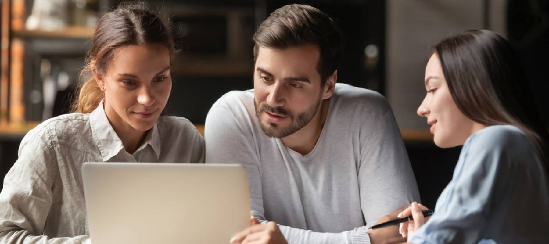 Three people going over numbers for a mortgage