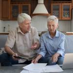 Worried older age family couple pensioners check bills