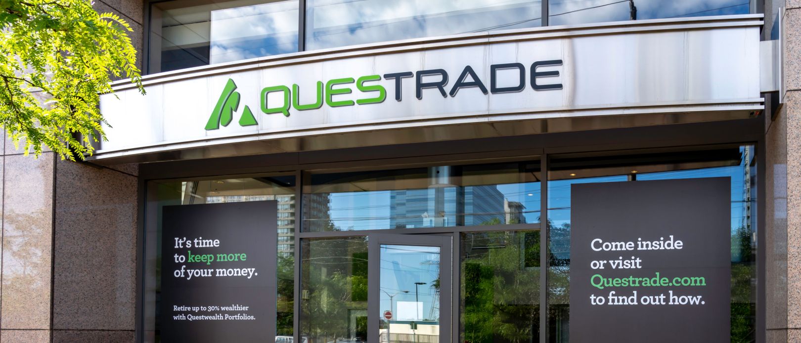 Toronto, Ontario, Canada - July 31, 2019: Questrade office entrance in Toronto, Canada. Questrade, Inc. provides online brokerage and stock trading services to independent investors in Canada.