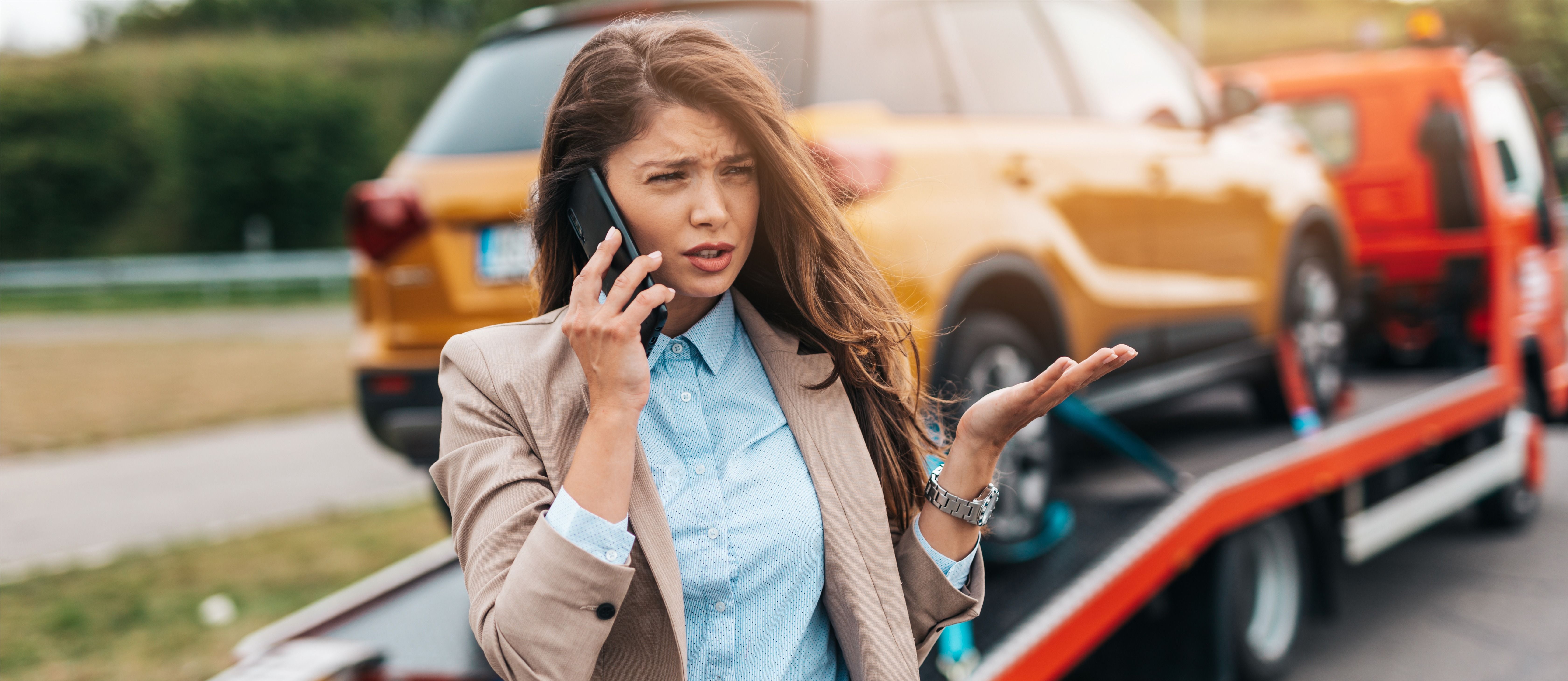  Business woman calling towing service helping her on the road