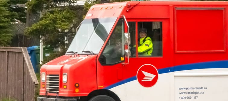 Calgary, Alberta, Canada. May 22, 2024. A close up to a Canada Post worker driving a delivery shipping vehicle.