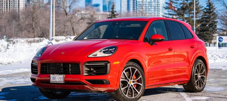 A Red Porsche Cayenne in a parking low on a sunny day during the winter
