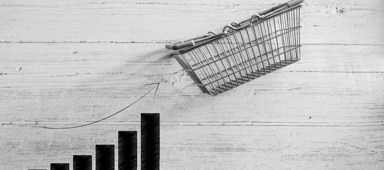 empty shopping basket with bar chart stats going up,concept of positive market trends