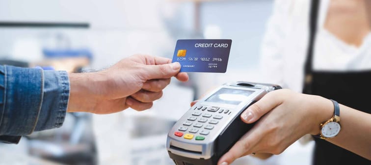 Customer using credit card for payment to owner at cafe restaurant, cashless technology and credit card payment concept