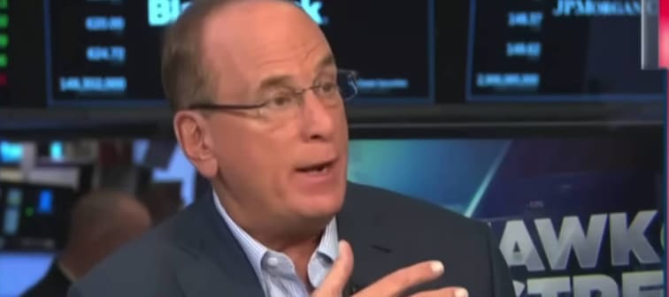 Blackrock CEO Larry Fink speaking with his hands held up, looking to the right of the picture