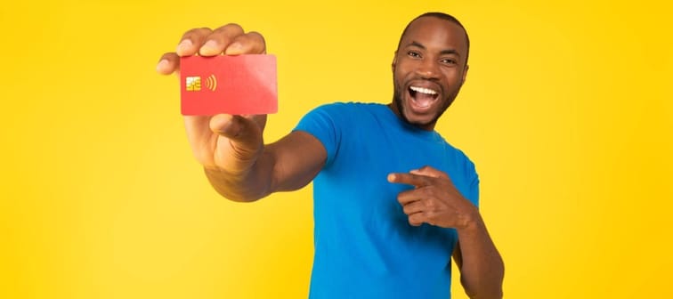 Male holding credit card and looking excited