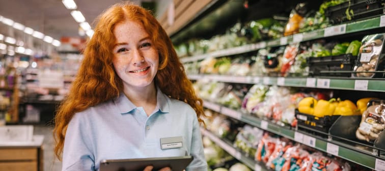 Young student working at first job in grocery store