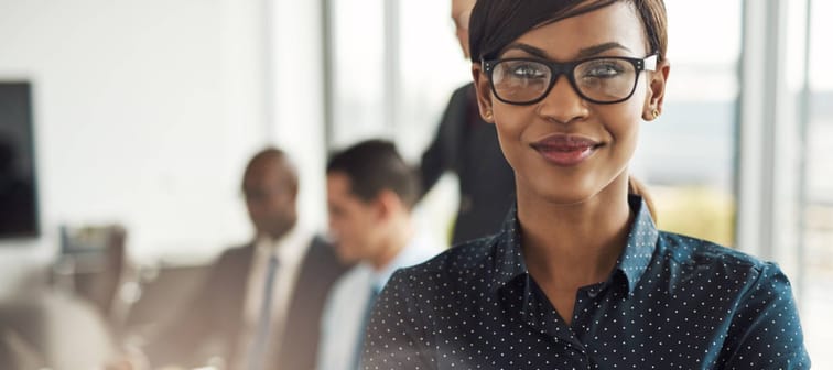 Young professional woman looking pensively at the camera