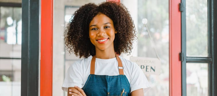 Young business woman stands in front of her store