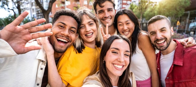 Cheerful friends taking selfie pic with mobile phone device