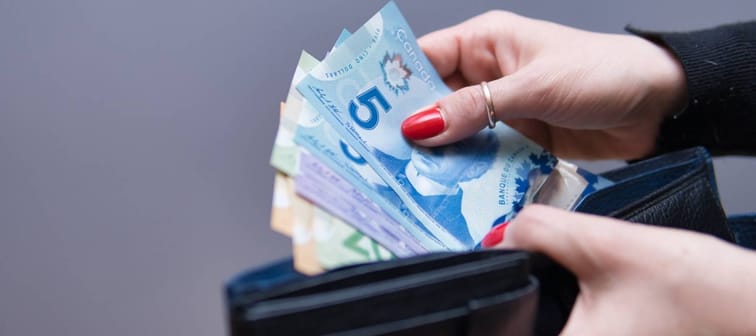 woman has Canadian dollars in her hands