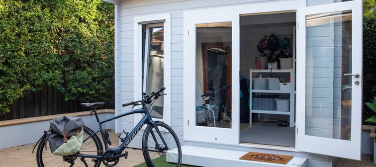 Homeowner bikes up to a backyard secondary suite