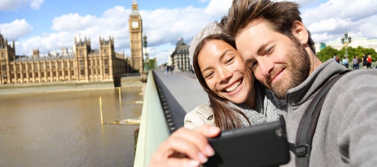 London tourist couple taking photo near Big Ben