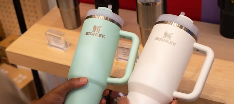 Buyer comparing two Stanley tumblers at store