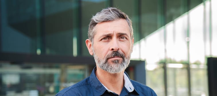 Older man looking pensive at the camera