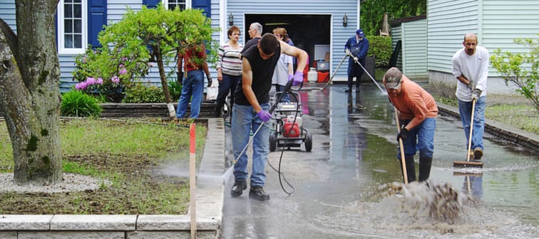 Richelieu Valley, Quebec, Canada June 11, 2011: Volunteers cleanup outside of a suburban home follow catastrophic flooding