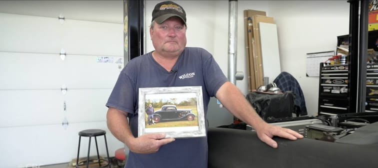 Wayne Evoy holds a picture of his classic car