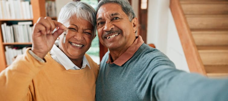 Older couple smiling holding house keys