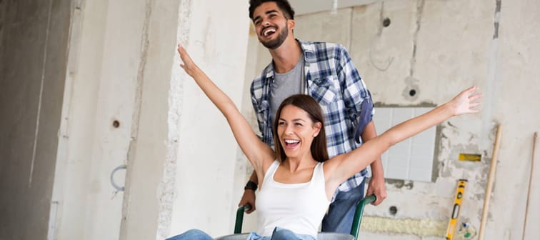 Young couple happily renovating their home