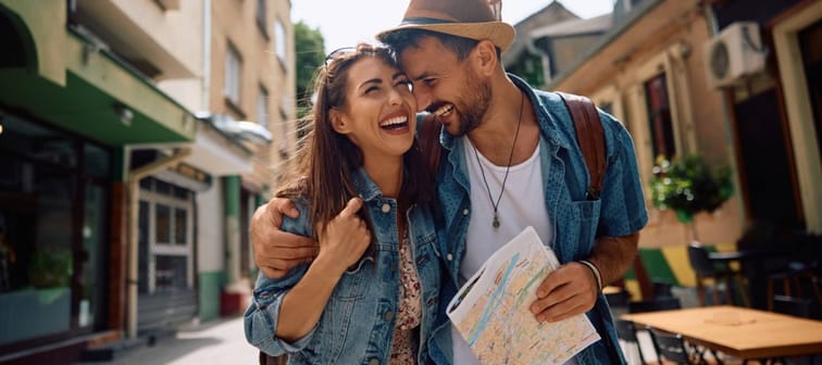 Carefree couple walking in the city during their summer travel.