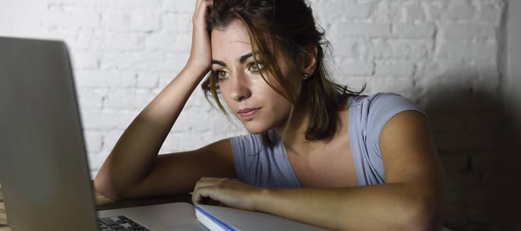 Young woman stressed at computer