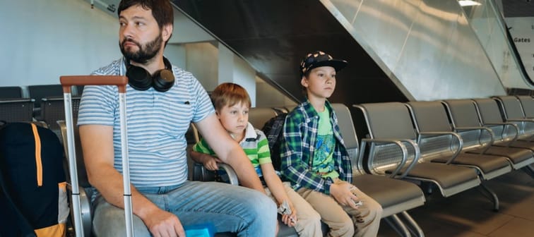 Father and children stressed at the airport