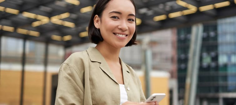 Young happy woman holding a cellphone