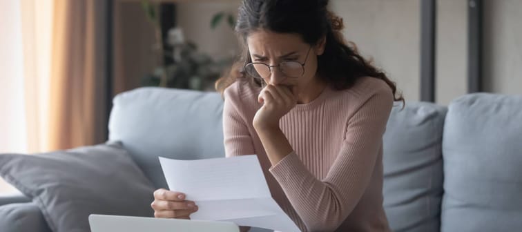 Stressed woman looking at bills