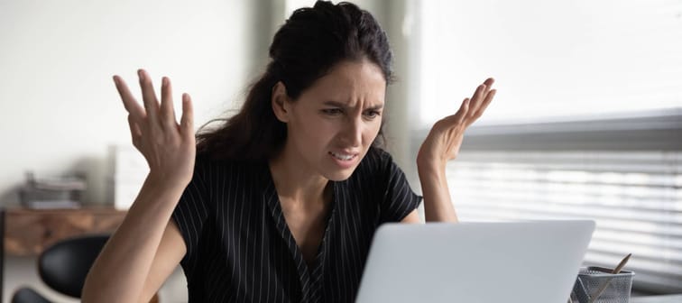 Angry looking woman on computer