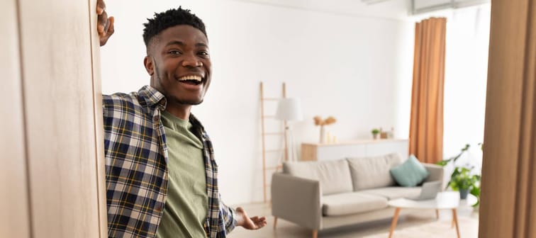 A young men welcomes you into his home.