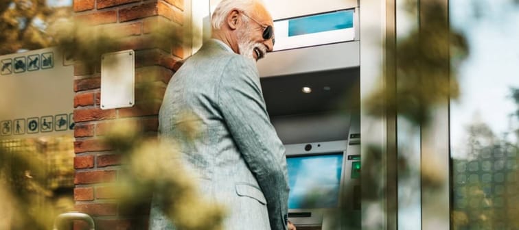 Older man using ATM