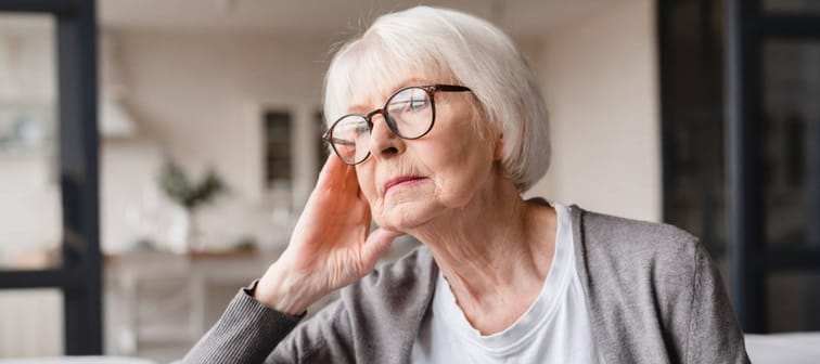 Morose looking elder woman