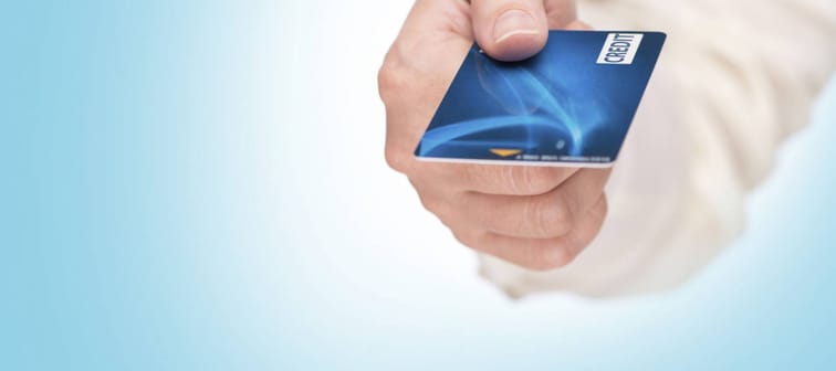 closeup of hand hold blue credit card. focus on card. showing blue credit card