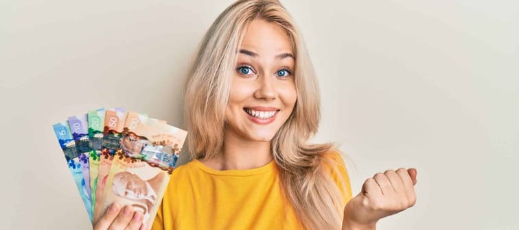 Canadian Millennial woman holding cash