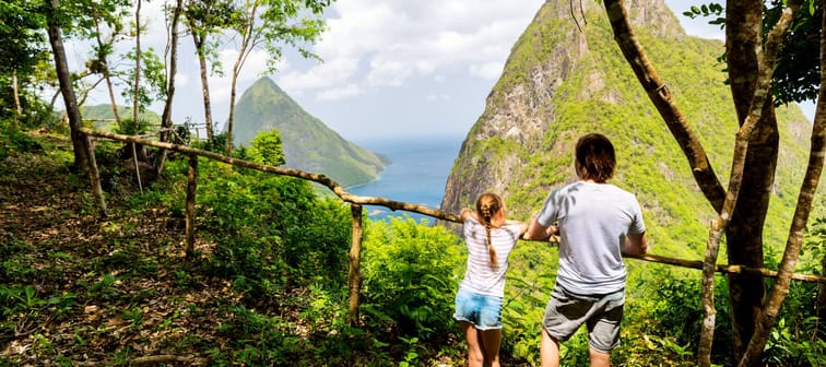 Back view family of father and daughter enjoying scenery of Piton mountains on St Lucia island in Caribbean