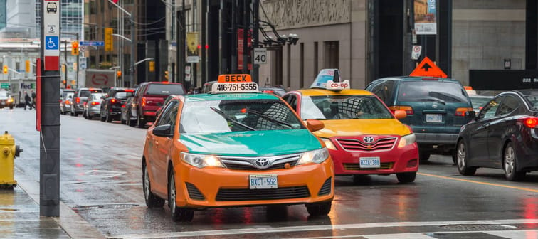 2 taxis in Downtown Toronto on a rainy day